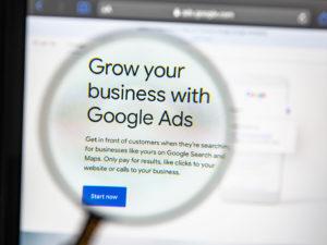 UK SEO agency - Google Ads website under a magnifying glass