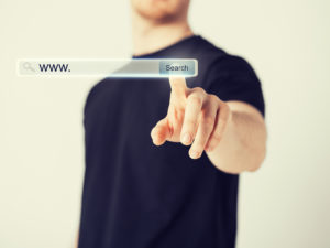 digital marketing - male hand pressing Search button