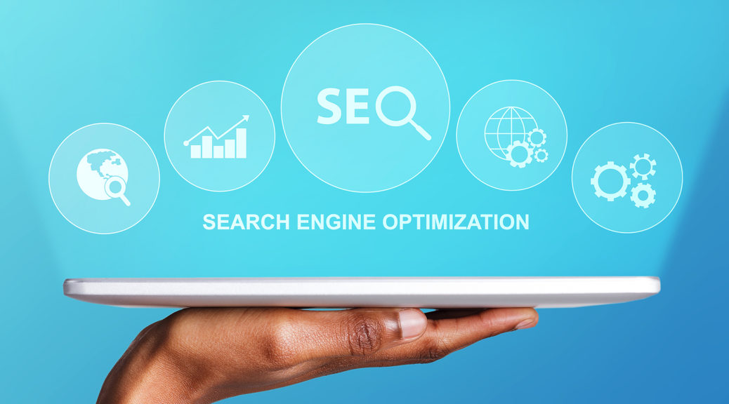 digital marketing manchester - Hand-Holding-Digital-Tablet-With-Seo-Word-And-Seo-Optimization-Tools