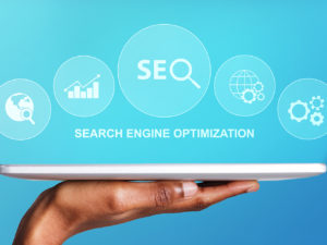 digital marketing manchester  - Hand-Holding-Digital-Tablet-With-Seo-Word-And-Seo-Optimization-Tools